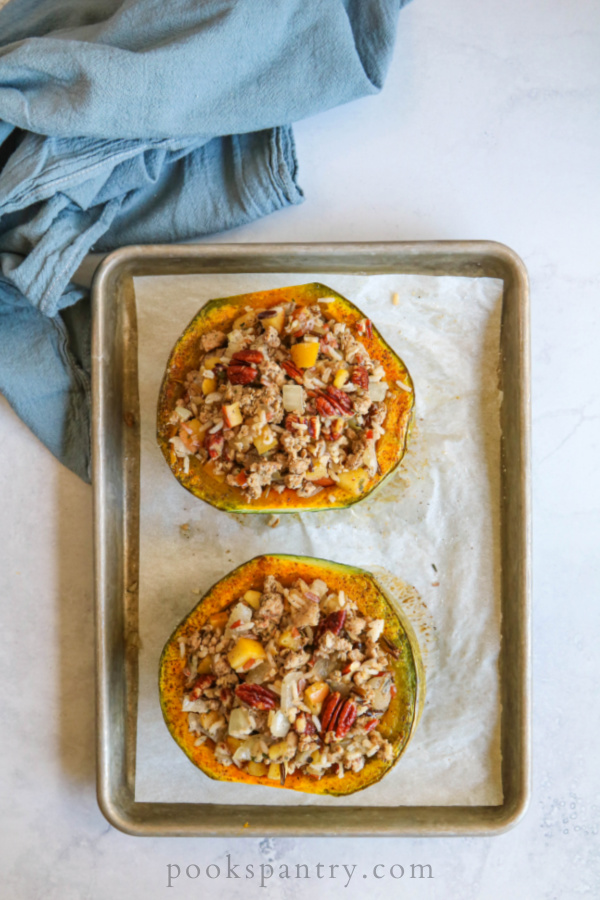 stuffed squash ready to bake in the oven on sheet pan