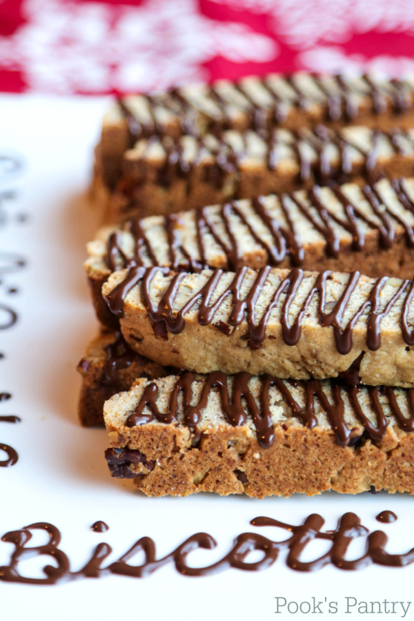 butter pecan biscotti with chocolate drizzle on platter