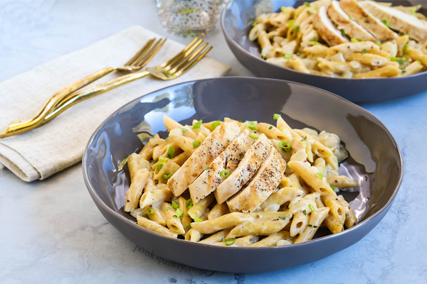 creamy Dijon pasta with chicken in gray bowl