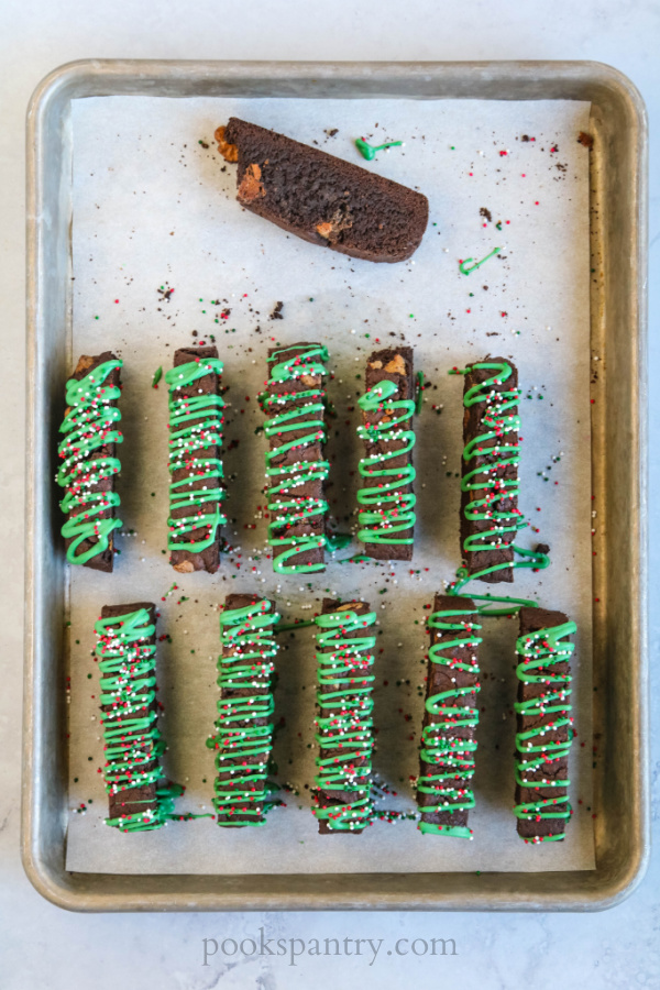 chocolate mint biscotti with green drizzle and sprinkles
