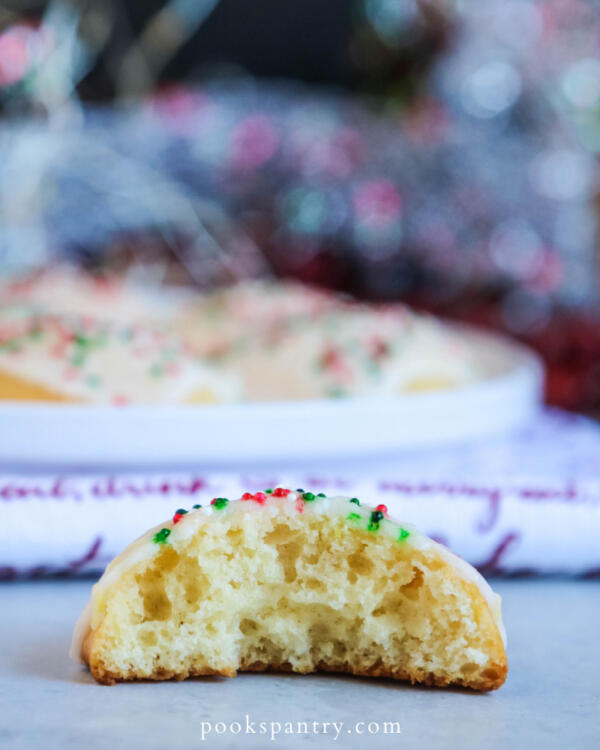 Cut open ricotta cookie with lemon glaze and sprinkles.