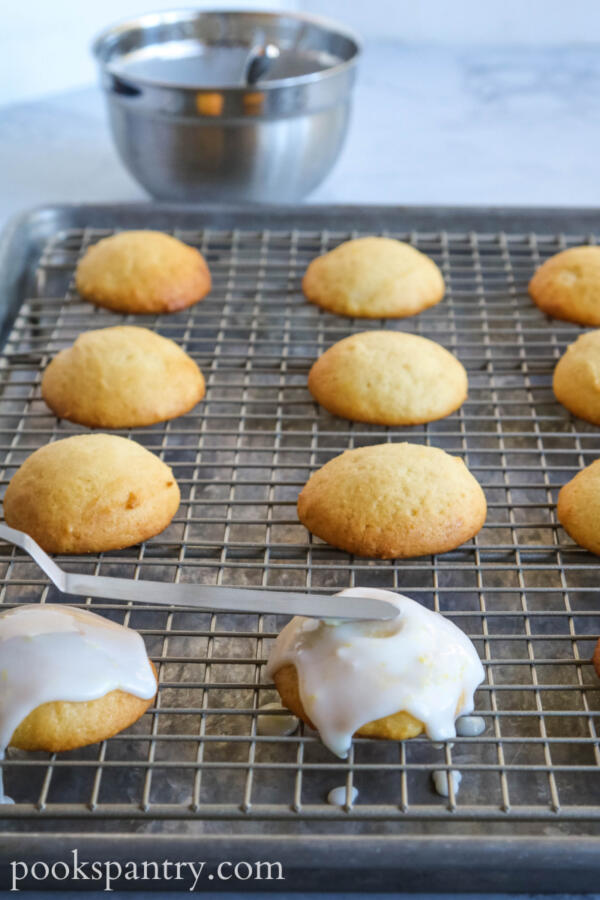 Spreading lemon glaze on ricotta cookies.