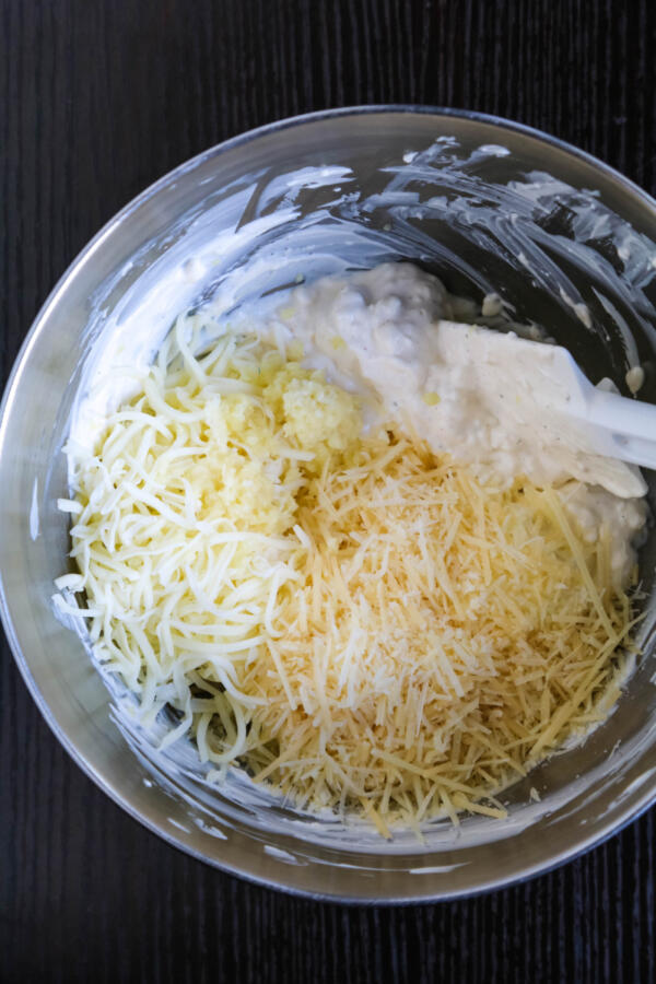 mixing bowl with cheese, garlic, cream cheese, sour cream and mayo