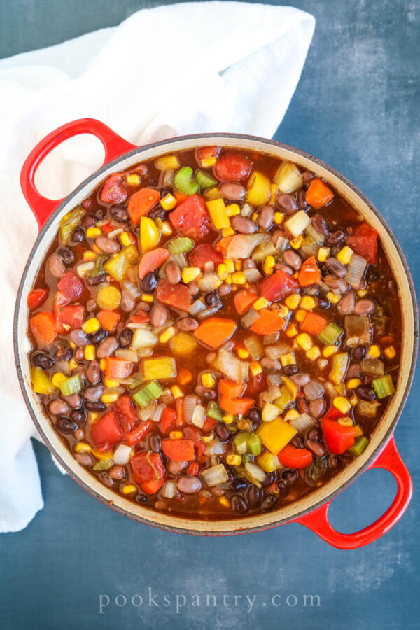 vegetables and beans ready to cook in red pot