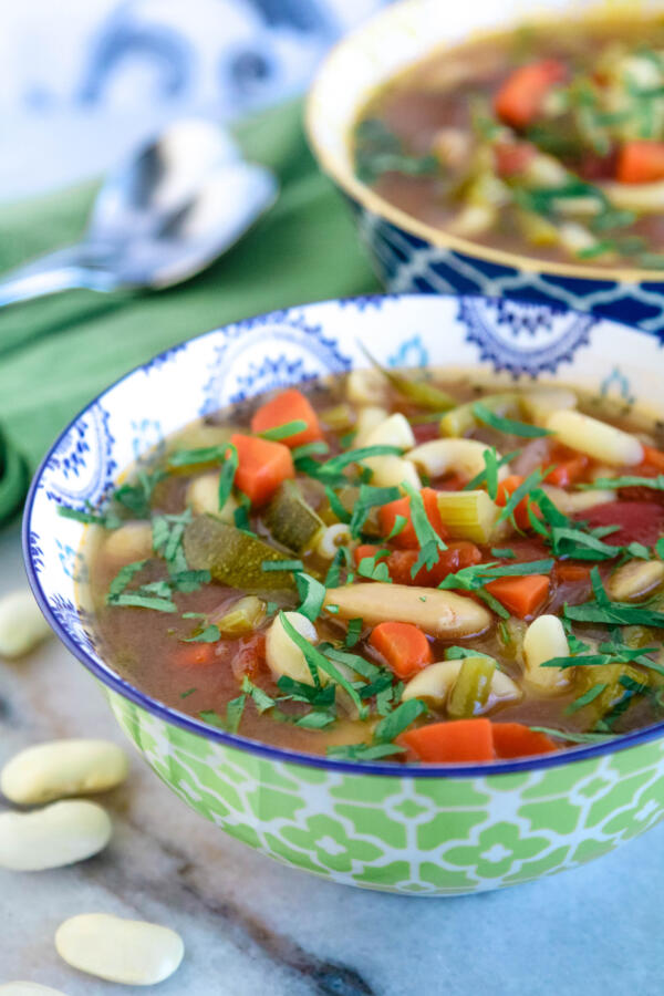 Minestrone soup from scratch in green and white bowl