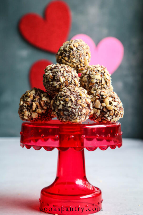 coconut truffles on red cake stand