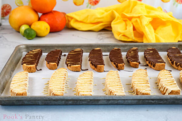 chocolate drizzled biscotti on sheet pan