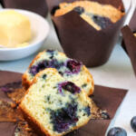 Blueberry muffins in brown baking papers.