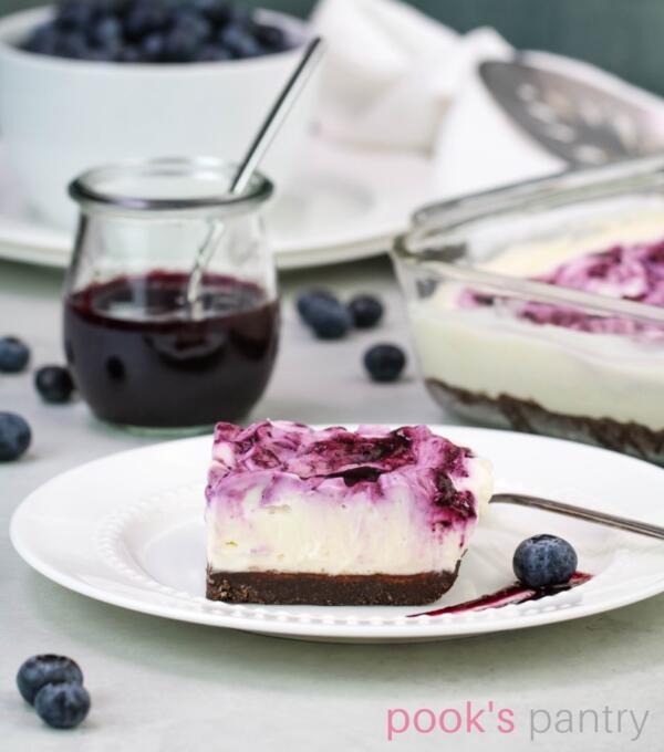 No bake cheesecake with blueberries on small white plate.