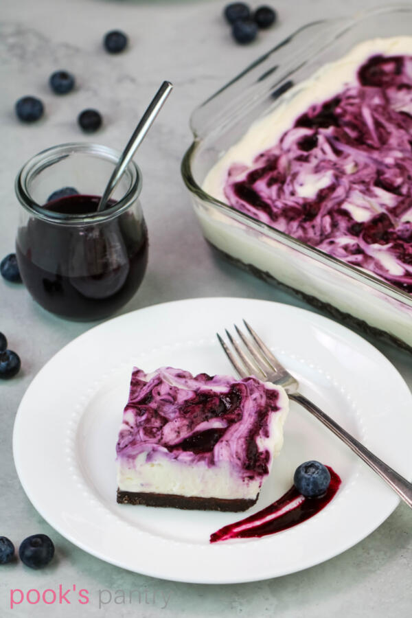 Blueberry swirl no bake cheesecake on plate with antique fork.