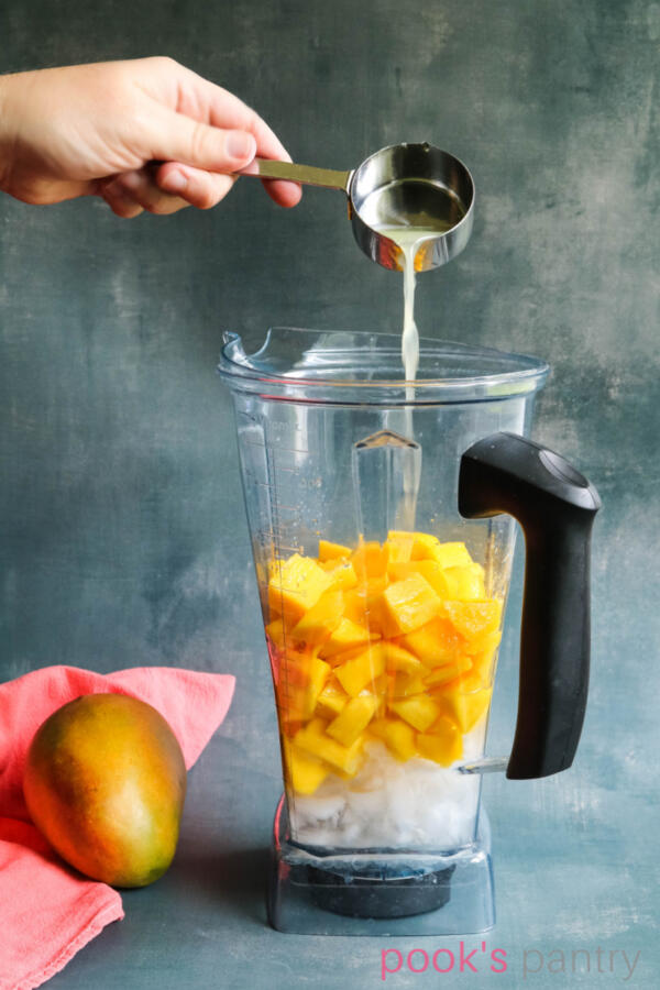 Making fresh mango daiquiri recipe in Vitamix blender.