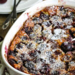Sweet cherry clafoutis in white baking dish.
