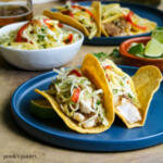 Fish tacos on blue plate.