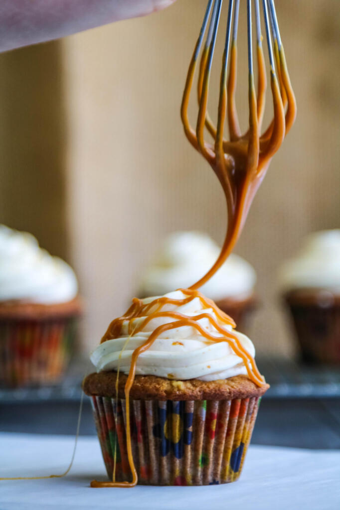 How to drizzle caramel on cupcakes with a whisk.