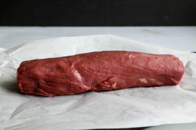 Raw chateaubriand on parchment paper.