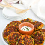 Original veggie cakes recipe on a small plate with dip.