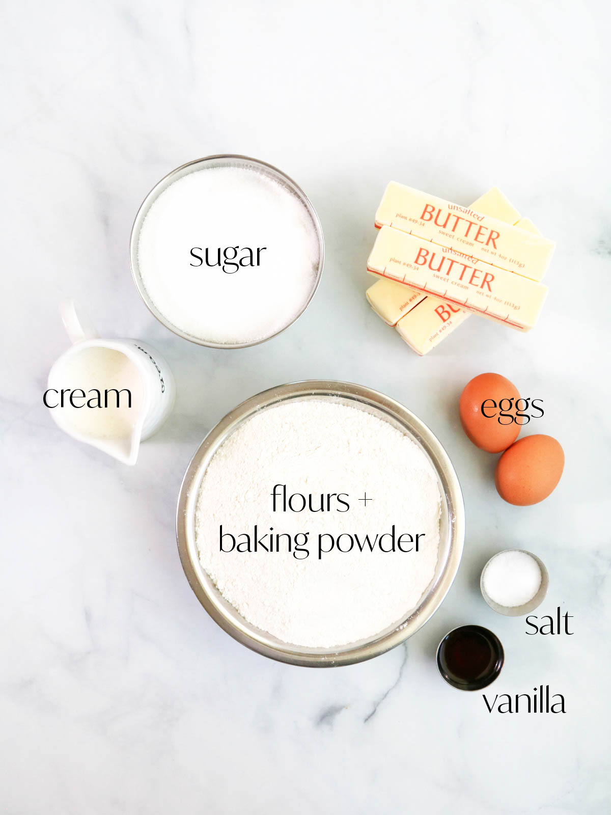 Ingredients for classic sugar cookies on a white background.