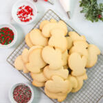 Classic Christmas sugar cookies on a cooling rack.