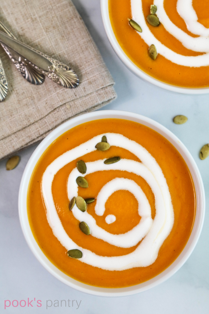 Cream swirls on top of soup.