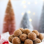 Peanut butter whiskey balls in small white bowl.