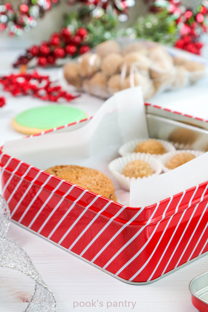 Red and white cookie tin with cookies inside.