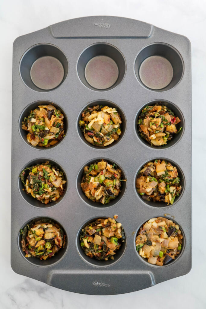 Diced vegetables in muffin tin.