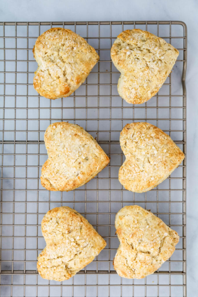 Heart-shaped scones on cooling rack.
