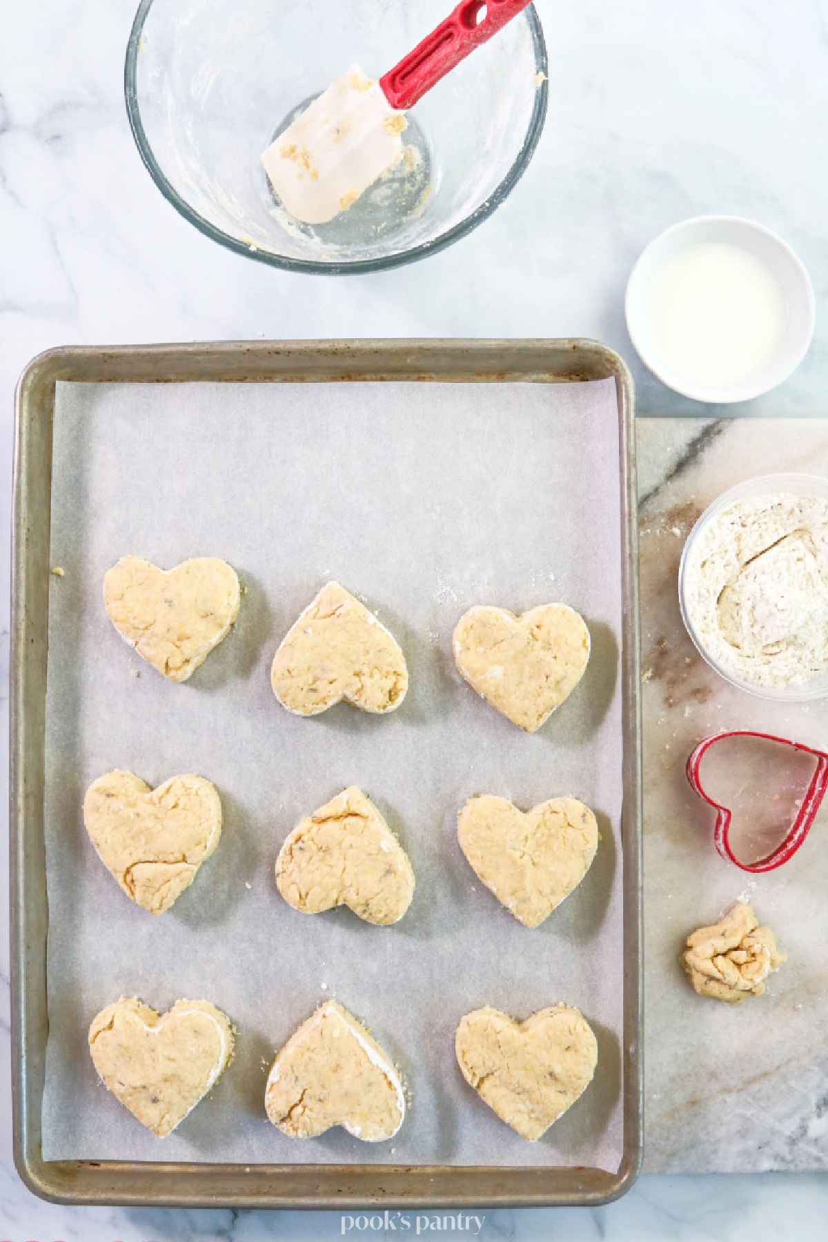 Cutting out heart-shaped scone dough.