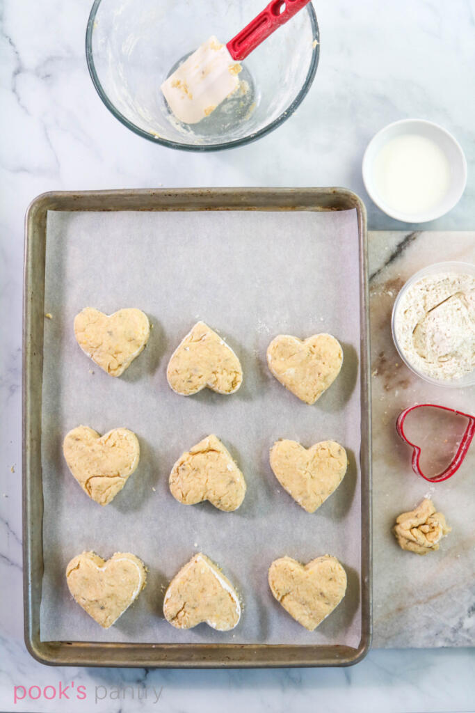 Cutting out heart-shaped dough.