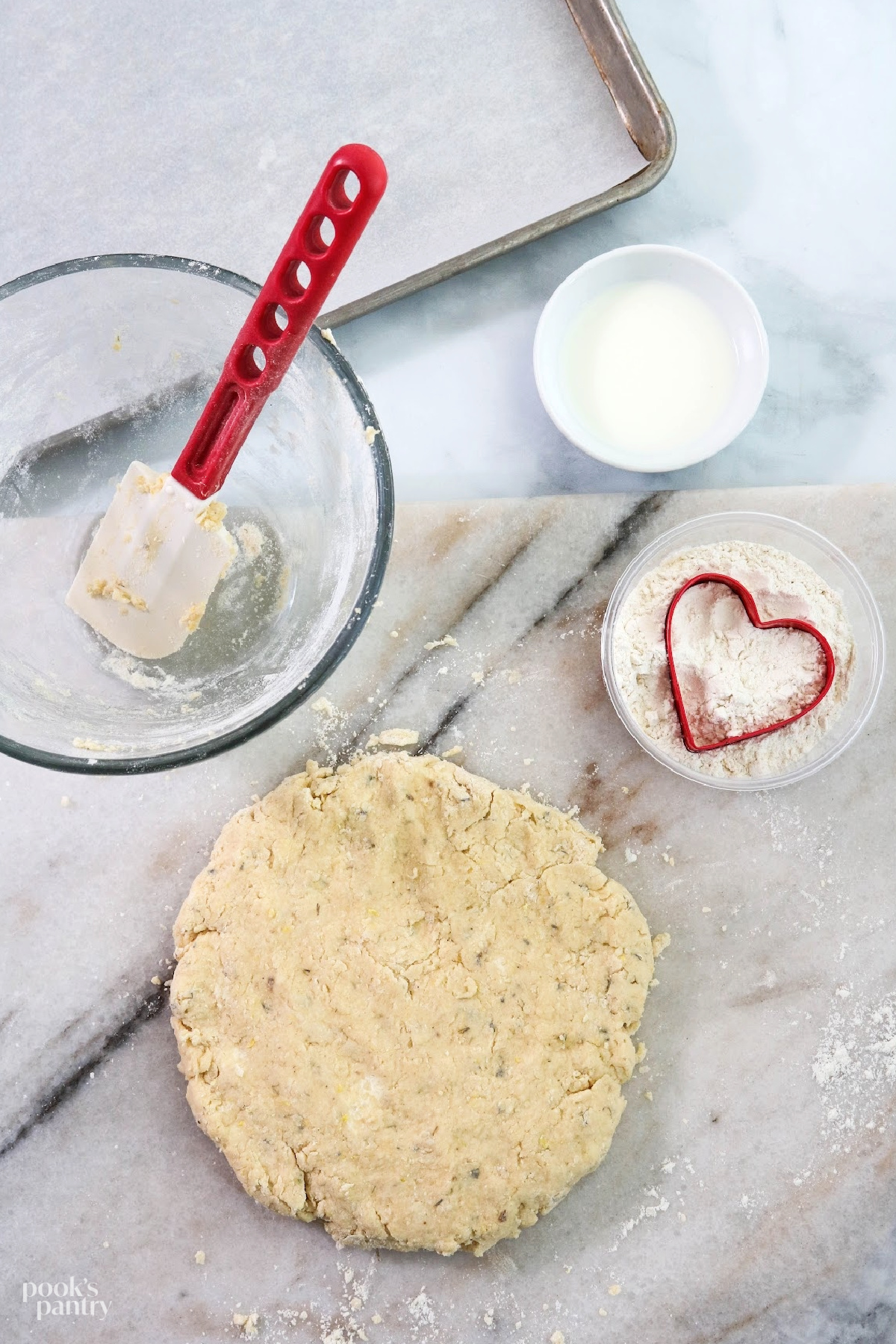 Lavender dough on marble countertop, ready to cut out scones.