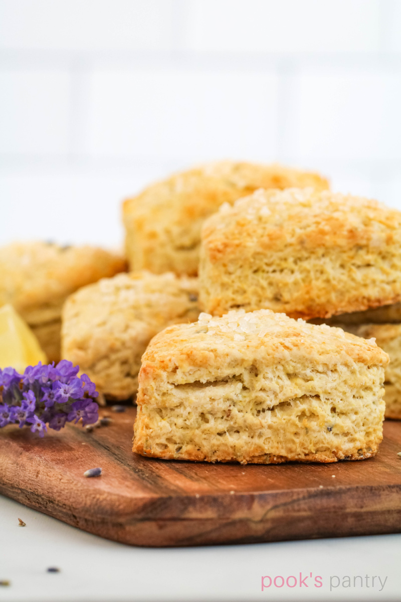Heart-shaped scones on board with flowers.