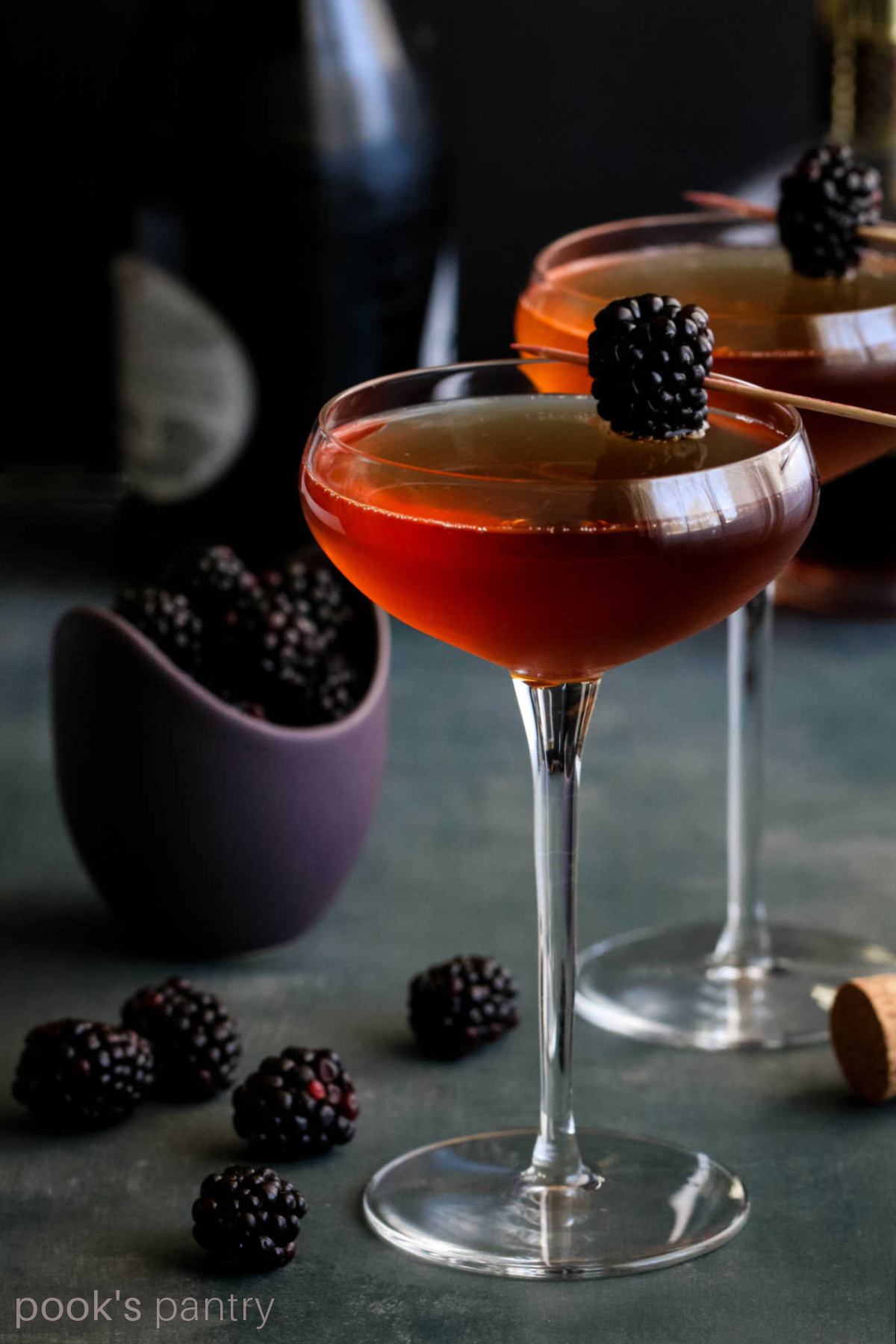 Valentine's Day cocktail in coupe glasses with blackberries.