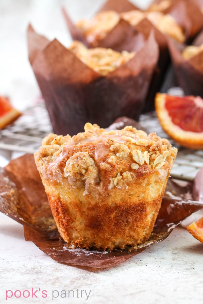 Muffins in tulip paper liners with fruit on the side.