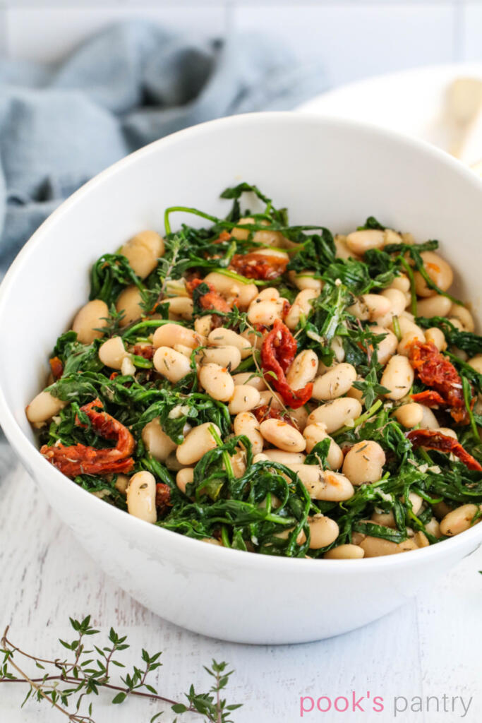 Cannellini beans with arugula and tomatoes.