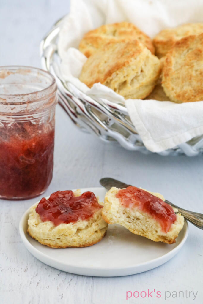 Easy biscuit recipe from scratch on white plate with jam.