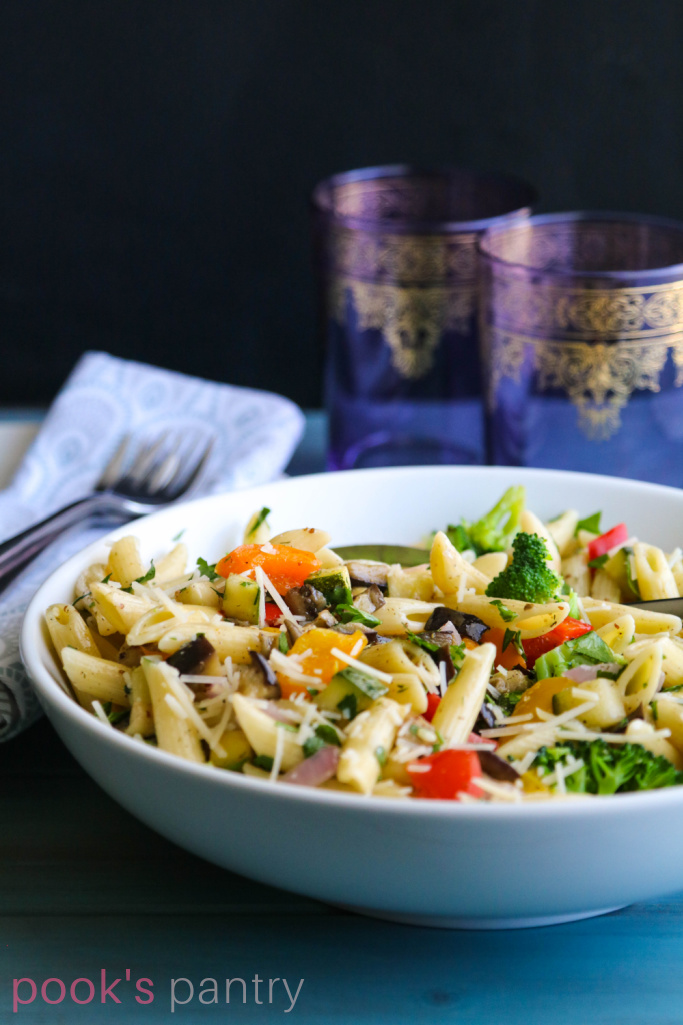 Oven roasted vegetable pasta in white bowl.