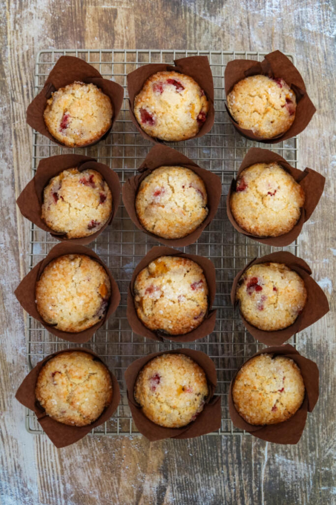 Strawberry peach muffins on cooling rack.