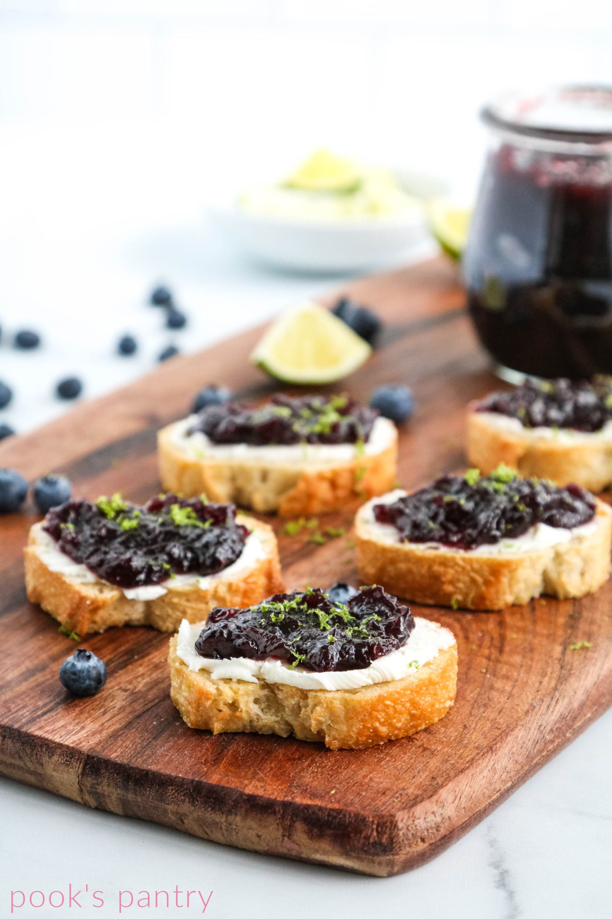 Crostini with blueberry lime jam and lime zest.