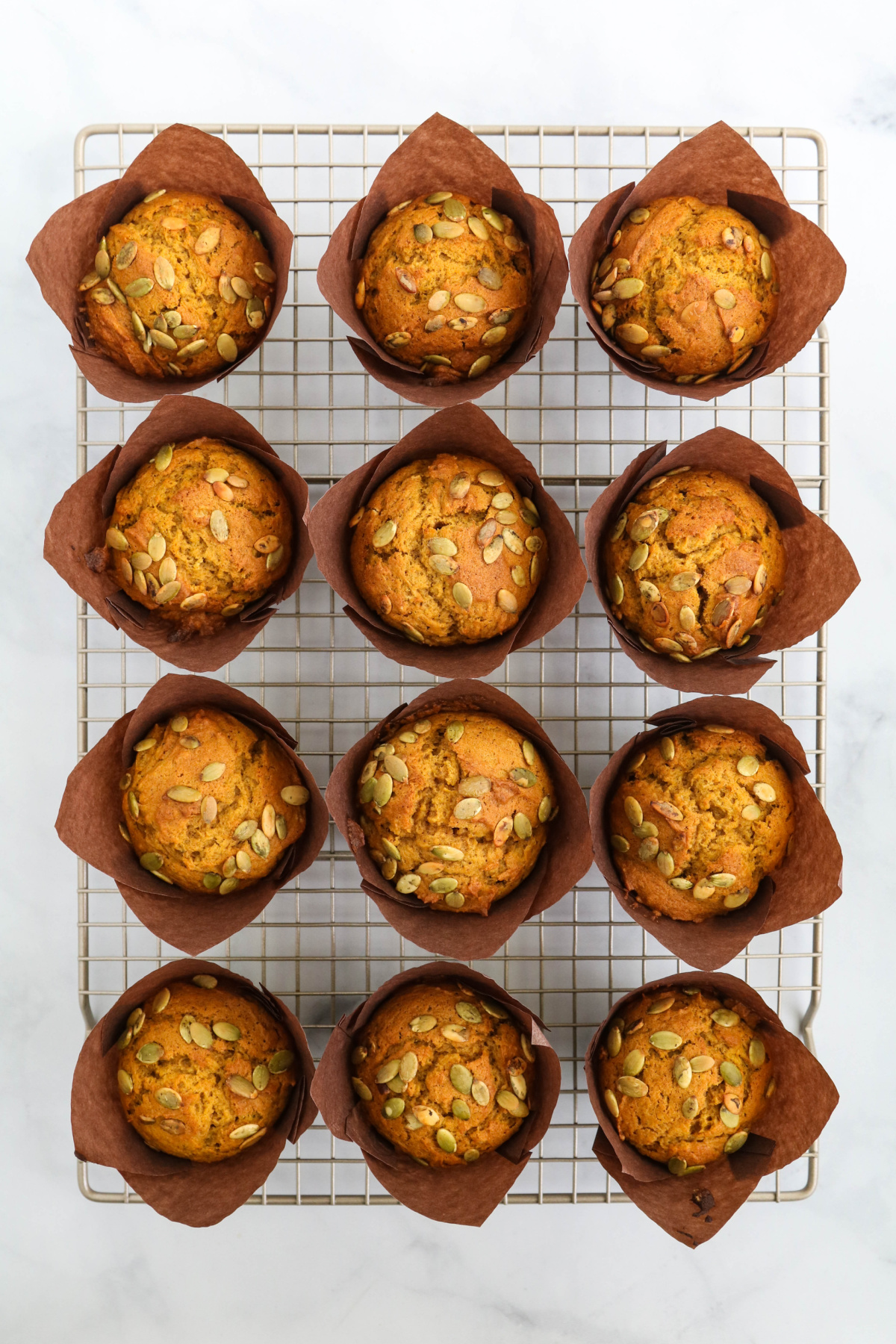 Pumpkin muffins on cooling rack.