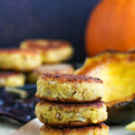 Three sisters squash fritters stacked on top of each other on parchment paper.