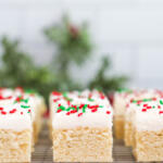 Close up of frosted Christmas sugar cookie bars on a cooling rack.
