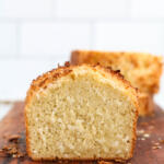 Coconut bread on a brown wooden cutting board.