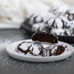Chocolate crinkles on black plate.