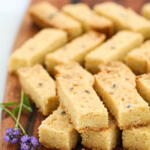 Lavender shortbread cookies on brown wooden board.