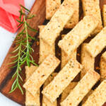 Shortbread cookie recipe with rosemary and grapefruit on a brown cutting board.