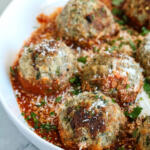 Weeknight meatballs with sauce and cheese in a bowl.