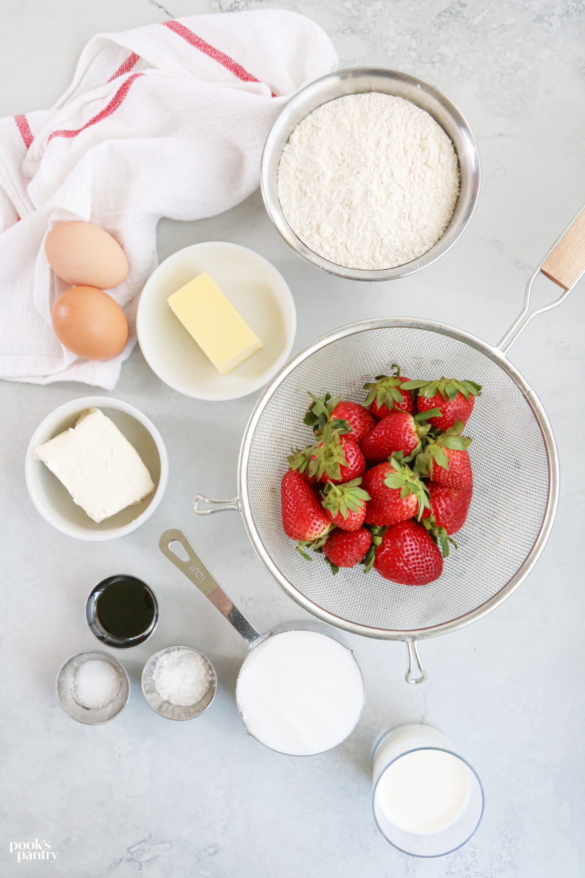 Ingredients for strawberry cream cheese pound cake on a light gray background.