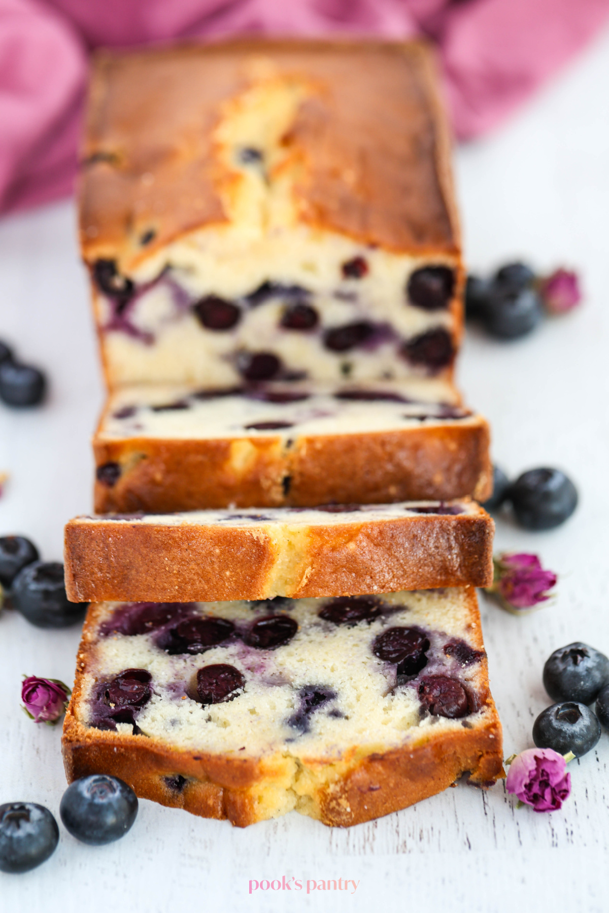 Blueberry cream cheese pound cake slices on a white background.