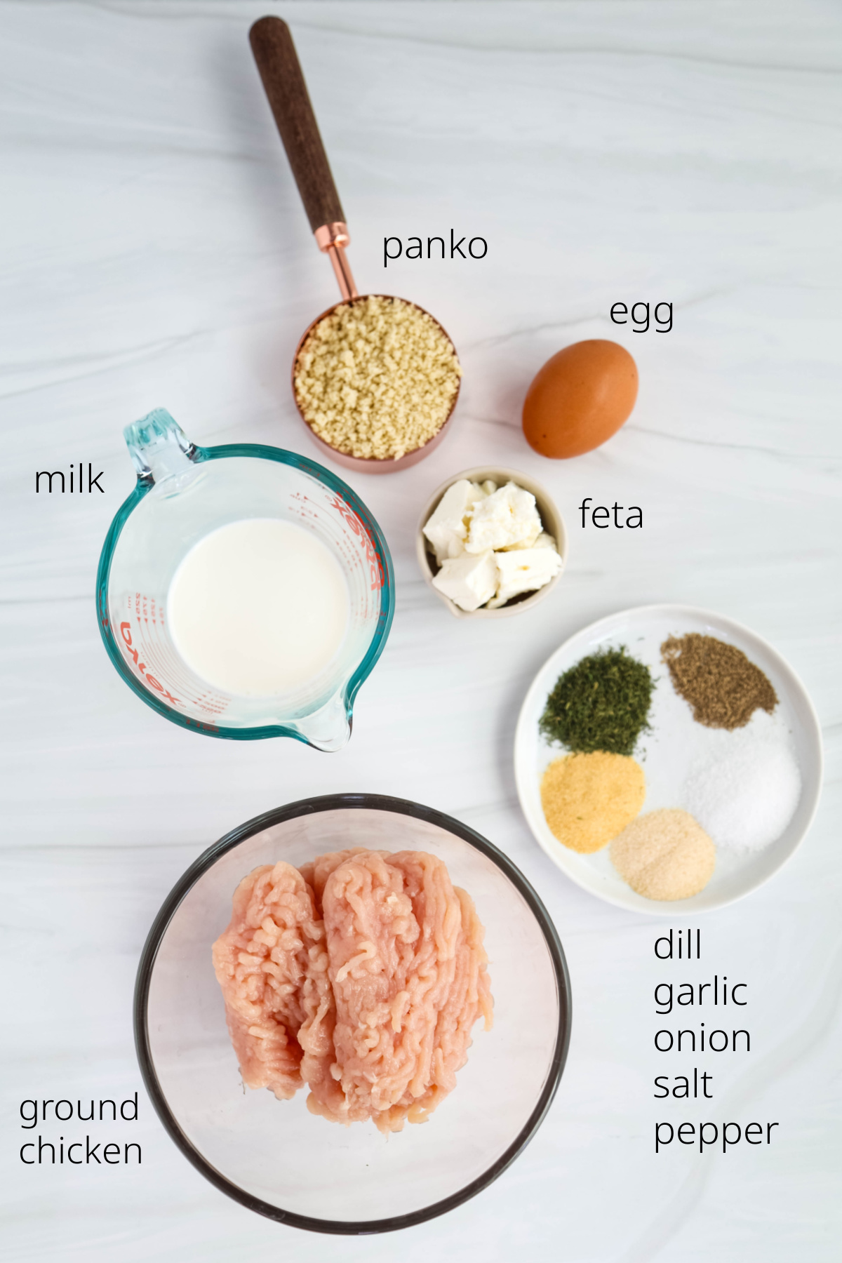 Ingredients for chicken meatballs on a white background.