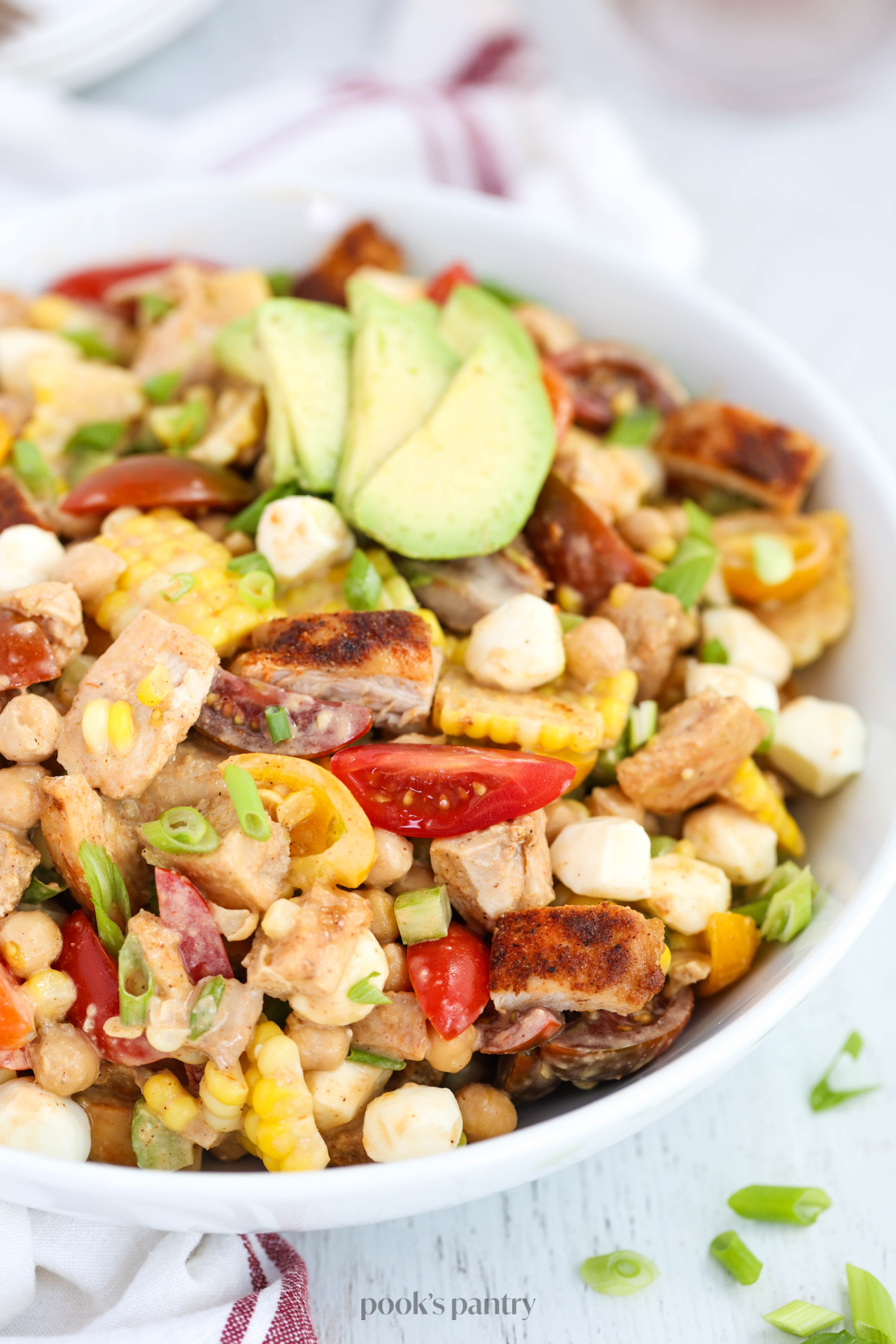 Close up of BBQ salad with sliced avocado on top.